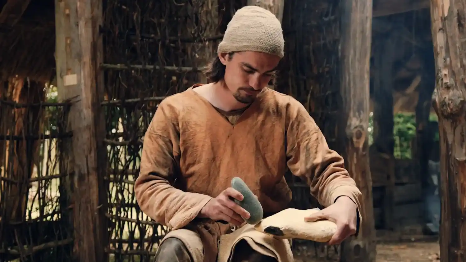 Man sharpening tools with a stone at Milton Keynes Museum&rsquo;s History Festival